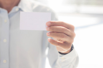 Hand with a white card.