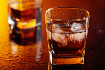 Glass of scotch whiskey with natural ice .