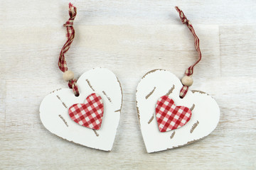 Two hearts of wood on wooden background