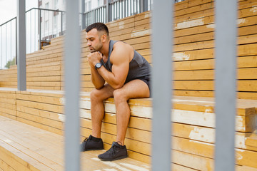 Athlete training in the open air. Workout on the playground.