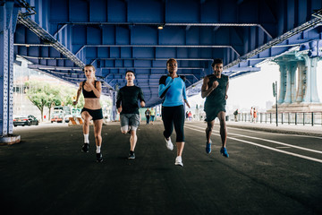 Group of urban runners running on the street in New york city, conceptual series about sport and fitness