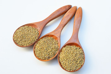 garam masala powder in wooden spoon on White background
