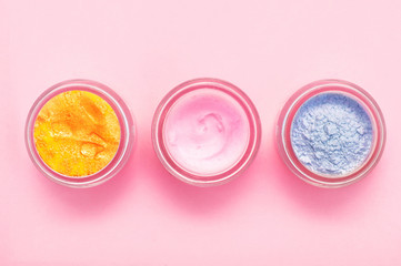 Obraz na płótnie Canvas Jars of body cream on color background
