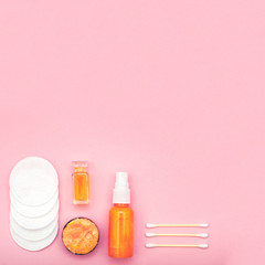 Gold cosmetic products on pink background