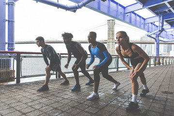 Group of urban runners running on the street in New york city, conceptual series about sport and fitness - obrazy, fototapety, plakaty