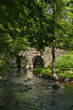 Ancient stone bridge, under the shade of trees