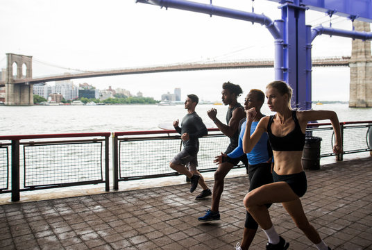 Group of urban runners running on the street in New york city, conceptual series about sport and fitness