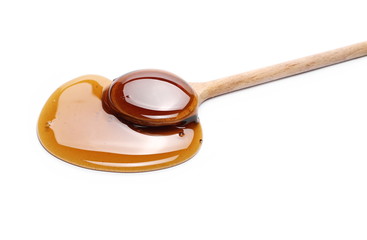 Honey with wooden spoon isolated on white background