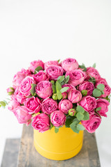 Beautiful spring bouquet in head box. Arrangement with mix flowers. The concept of a flower shop. Pink and yellow color. Work florist.