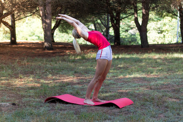 Young girl relaxed in the field doing yoga