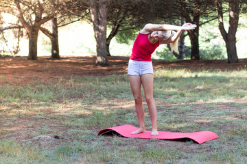 Young girl relaxed in the field doing yoga