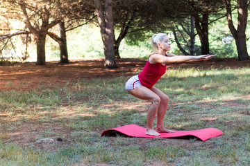 Young girl relaxed in the field doing yoga