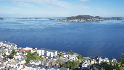 Fototapeta na wymiar Panoramic north-west views of the town of Alesund, Norway, from partway up Aksla, a hill that overlooks the town and the surrounding fjord, in a morning summer day