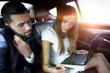 Confident businessman talking on the phone in car