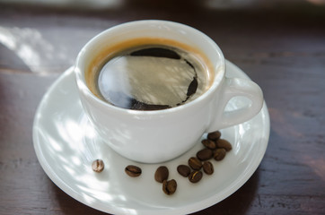 Black coffee on a wooden table in a coffee shop