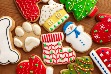 Fototapeta na wymiar Colorful christmas cookies set lay on wooden table. Holidays food and decoration concept.