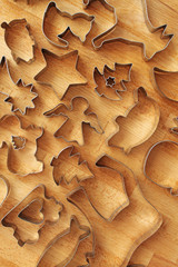 Different cookie forms on wooden background. Metal molds for cookies baking.