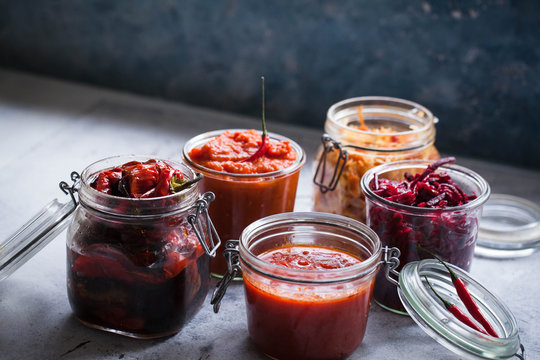 Fermented preserved jars red cabbage, beetroot, tomato sauce, red peppers fried Canning jar food 