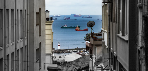 View through a narrow lane of the old town to the Bosporus with many ships