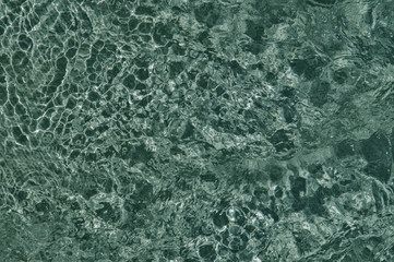 Close up. Bubbling water in the pool, blue texture of boiling water.
