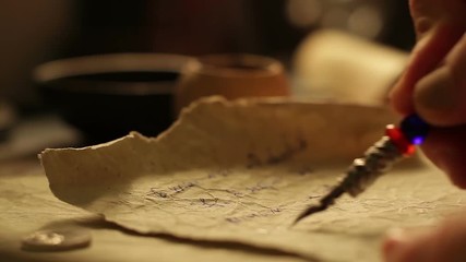 Male hand writing on a paper.
