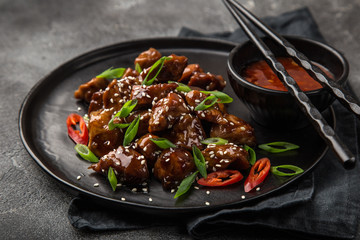 sweet sticky pork served with chives and  sesame seeds