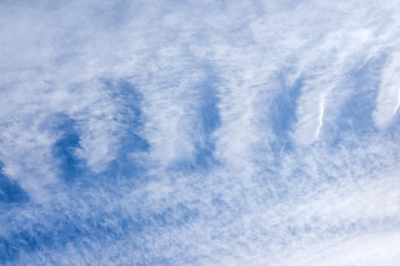 feather clouds in the bright blue sky