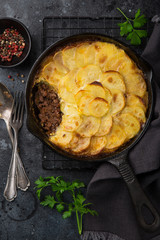 potato gratin with minced meat in cast iron pan
