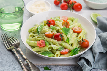 penne pasta with creamy avocado sauce and tomatoes