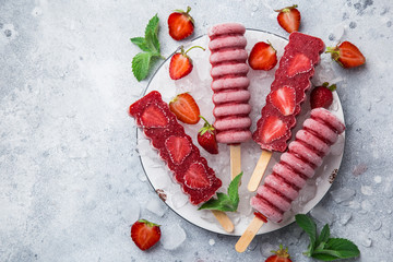 homemade strawberry  popsicles with fresh berries
