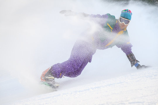 Beautiful Young Man With Vintage Retro Outfit Snowboarding On The Ski Slopes On A Winter Day In The Alps In The Brandnertal, Vorarlberg Austria