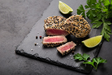 grilled sesame tuna steak on black background