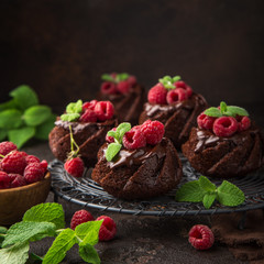 delicious chocolate muffins with chocolate topping and fresh raspberry