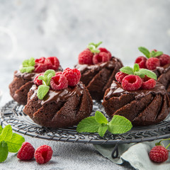 delicious chocolate muffins with chocolate topping and fresh raspberry
