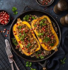 butternut squash stuffed with brown rice and vegetables, served with pomegranate and coriander