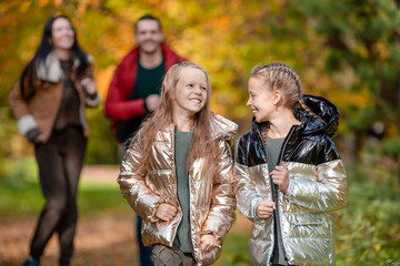 Portrait of happy family of four in autumn day