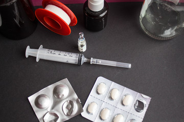 a syringe ampoule pills patch plaster on the black background