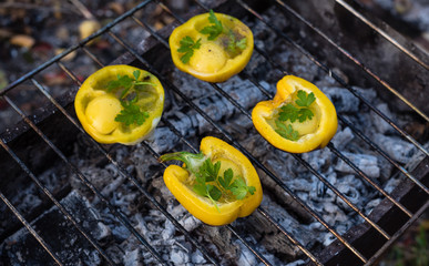 Eggs in Bolgarian pepper grilled on coals in the grill