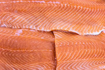 Fresh fillet salmon in ice on the market. Texture and background for copy space.