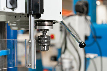 New Industrial Iron drill in workshop interior. Closeup on the drill. Tool store or exposition stand.