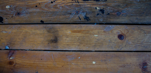 a wood background with black paint stains