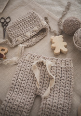 Crochet baby pants and hat on the table 