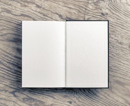 Open blank book on wooden background. Flat lay.