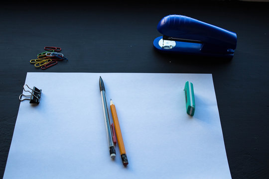 a paper and pencils stepler and colored