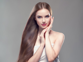 Beautiful long hair smooth brunette dark hair woman over gray background