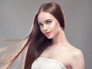 Beautiful long hair smooth brunette dark hair woman over gray background