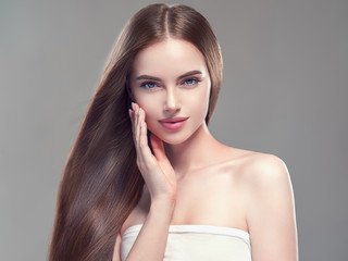 Beautiful long hair smooth brunette dark hair woman over gray background