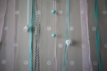 Tulle ribbons with decorative beads hanging on the wall