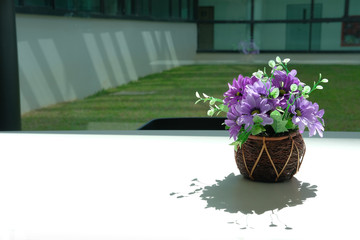 purple artificial flower on white table at office