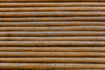 Log wall. Background of wooden logs. Wood texture.